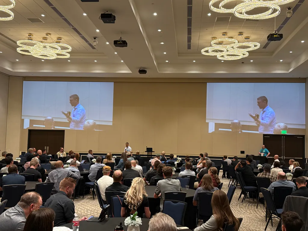 Jon Cheney speaking to a full conference room at an AI training event